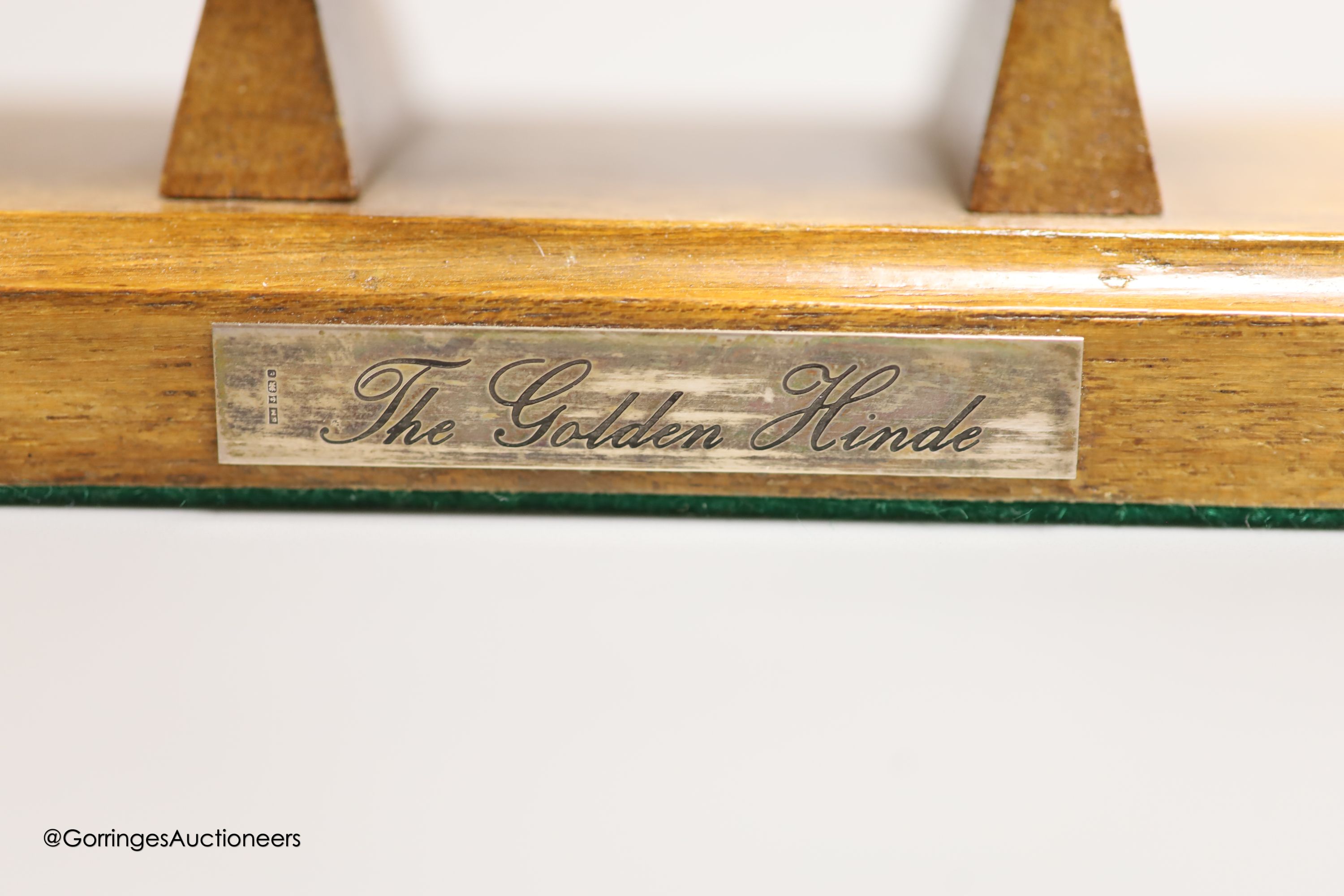 A modern Italian white metal (stamped 925) miniature model of the ship, 'The Golden Hind', (repairs), post 1968 mark, length 16cm, on a wooden stand